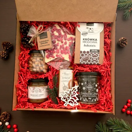 Wnętrze świątecznego pudełka z miodowymi dodatkami, herbatą i białą czekoladą gwiazdką