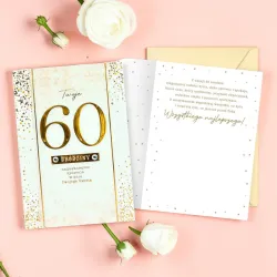 Karnet na 60 urodziny z jasnozłotą kopertą, złotą liczbą i życzeniami.