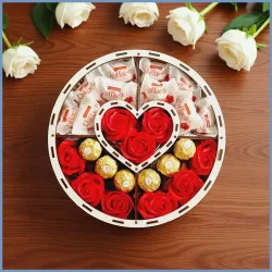 Zawartość pudełka widoczne słodycze i róże czerwone