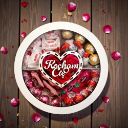 Zamknięte białe okrągłe pudełko z przezroczystą pokrywką i napisem „Kocham Cię”